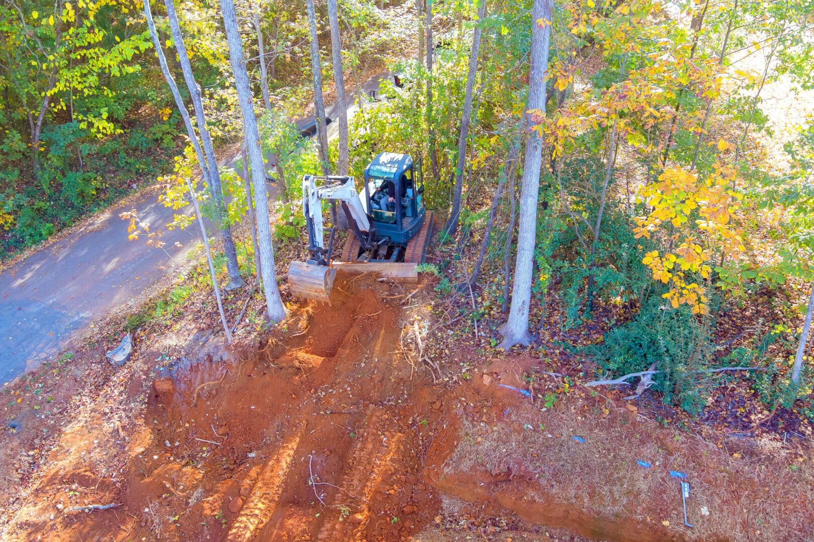 Salz Drainage and Excavating excavator digging into earth among trees 2026 01 09 08 09 25 utc