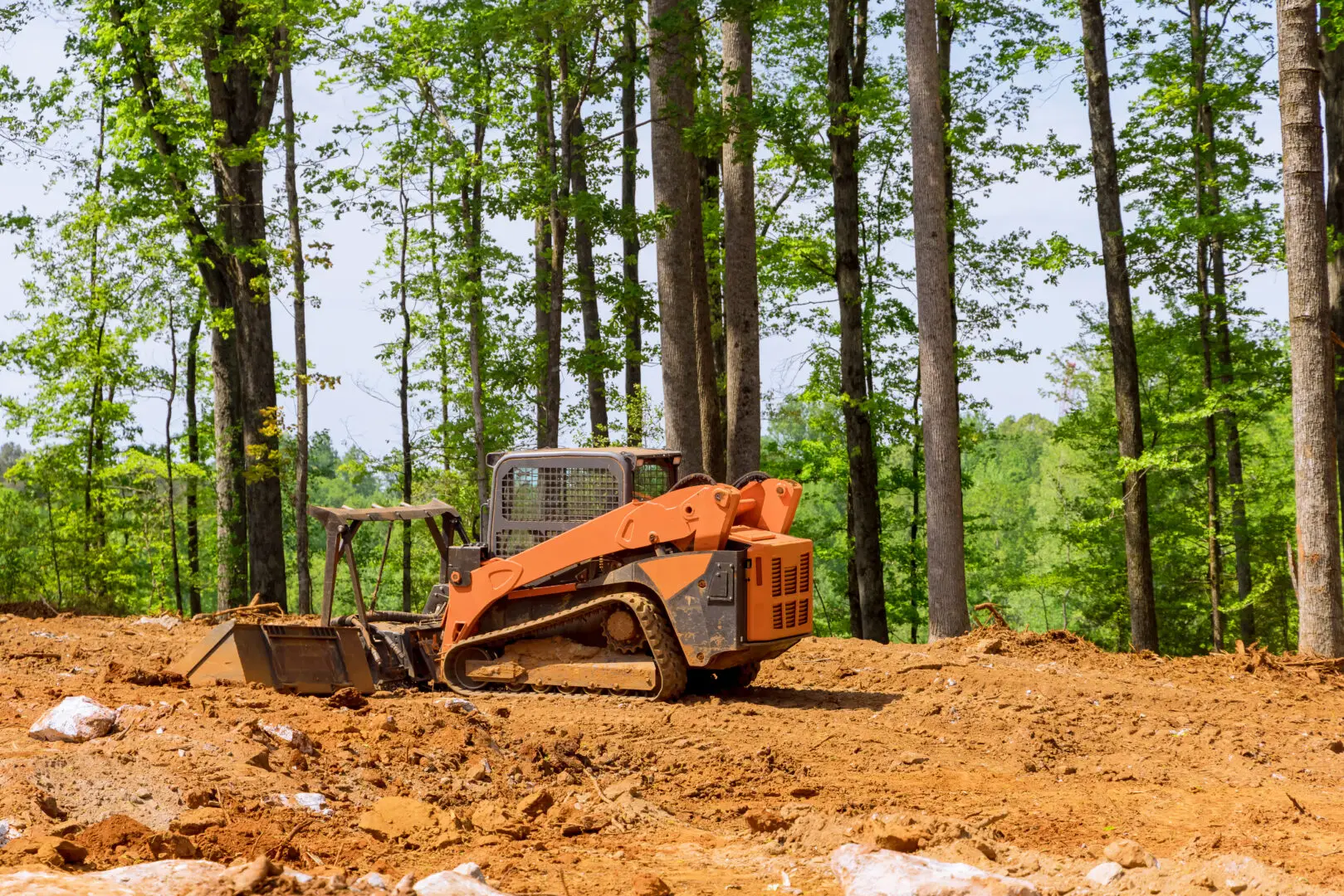Salz Drainage and Excavating orange construction equipment in rural forest land 2026 03 24 23 45 38 utc