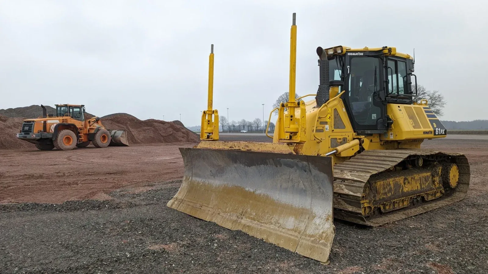Stock photograph of a bulldozer on a graded construction site